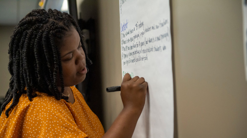 woman writing on whiteboard