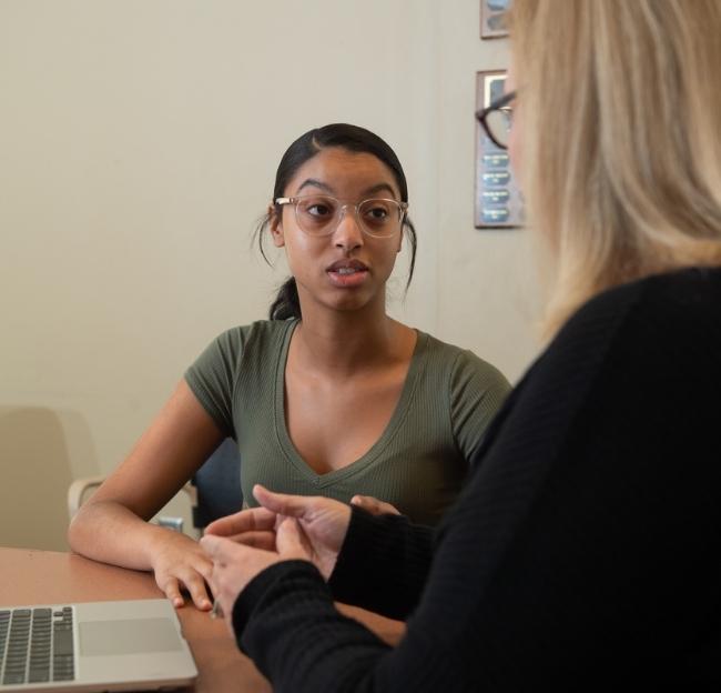 A student speaks with an adviser.