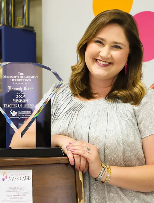 Portrait of Hannah Gadd Ardrey with crystal Teacher of the Year Award