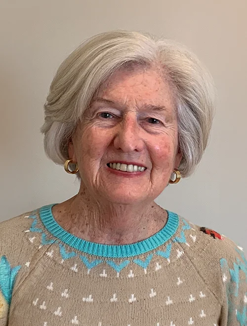 Smiling portrait person in sweater with white hair