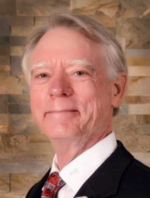 Person with gray hair smiling at camera
