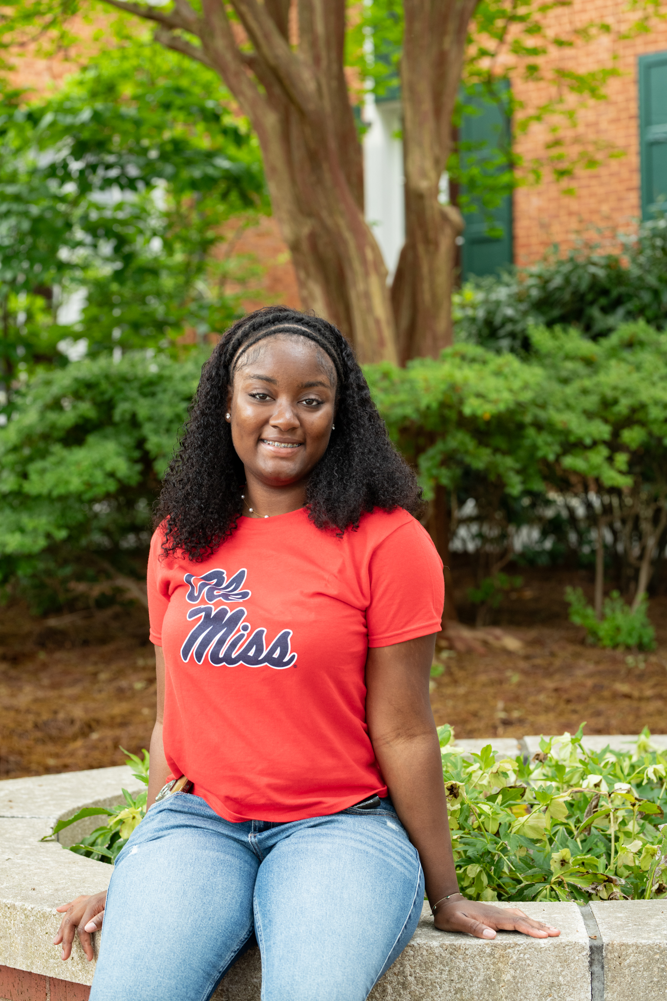 Alexa Stuart sitting outside a building on Ole Miss's campus. 
