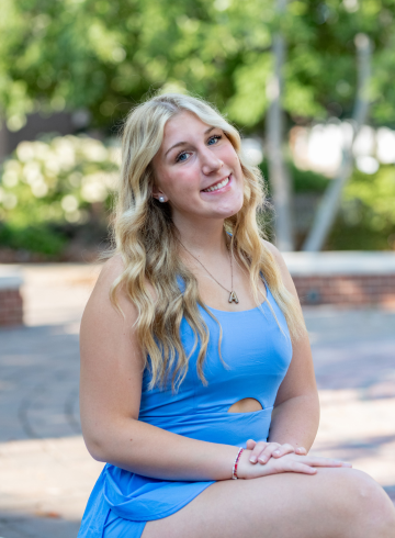 Ava Whitney sitting outside the student union. 