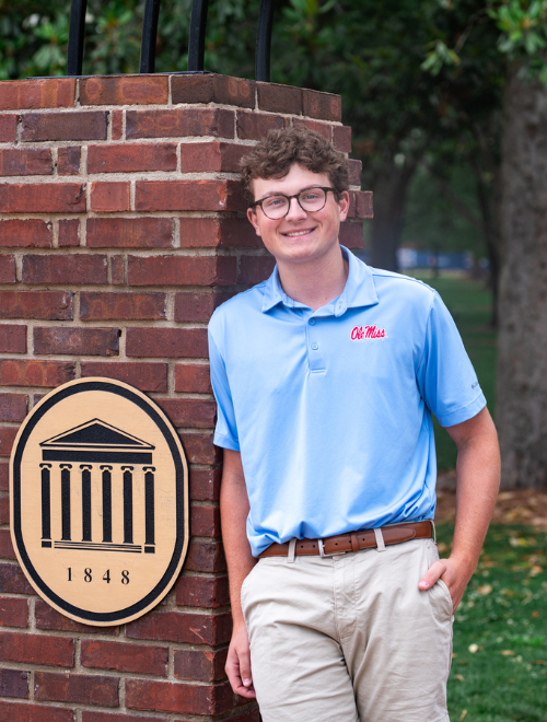 Billy Gates posing under the Arch of Champions at the Grove at Ole Miss