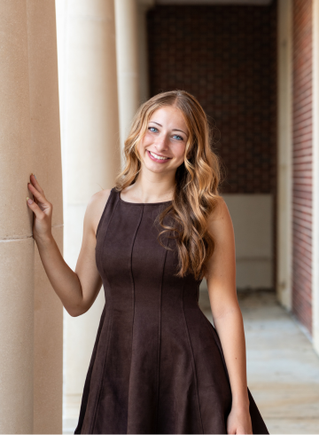Julia Vancura posing on Ole Miss's Campus by the library. 