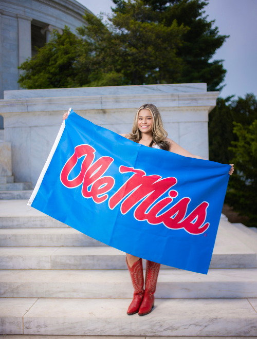 picture of Raquel holding an Ole Miss Flag.