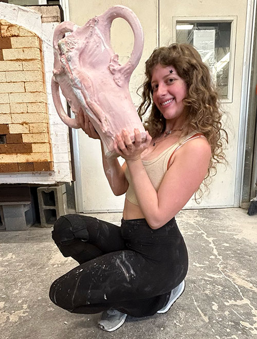 ruth hogue holding big ceramic sculpture