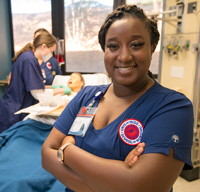 nursing student smiling while working in hospital setting