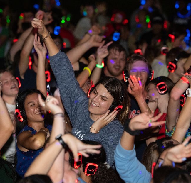 Students dance at night at the silent disco.