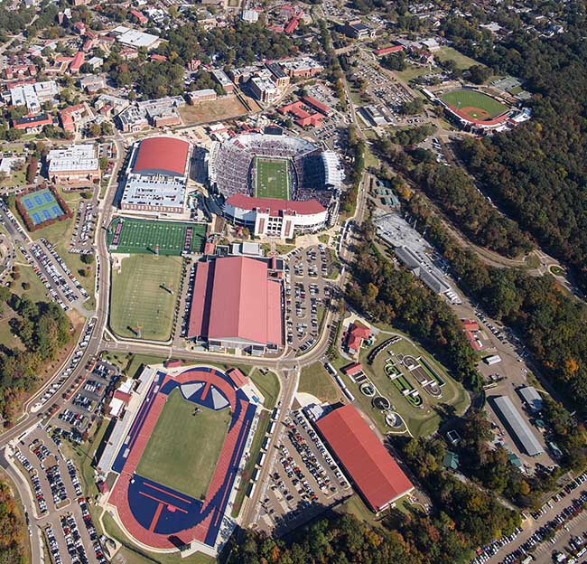 An aerial photo of the southeastern section of campus showing The Pavilion, Vaught Hemingway Stadium, Oxford University Stadium, the indoor practice facility, the track and field complex, the indoor tennis facility, and other facilities.