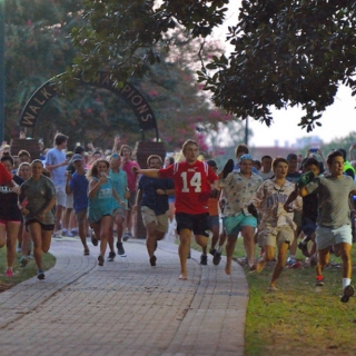 Students running through the Grove