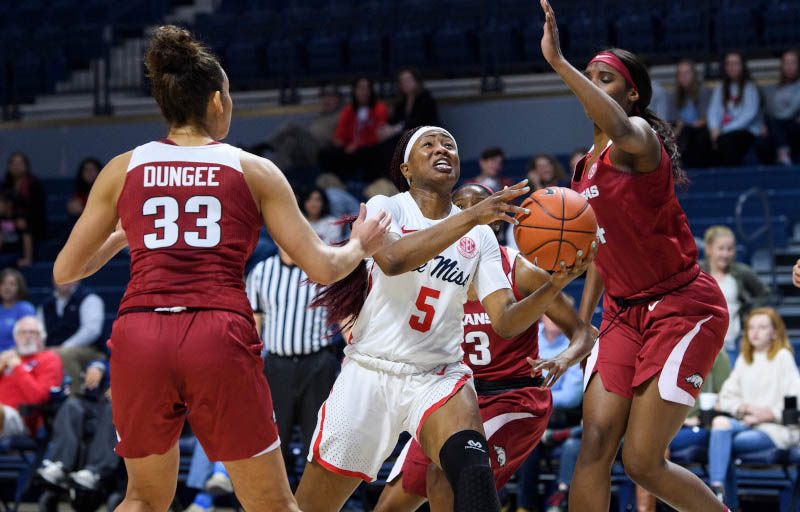 An Ole Miss women’s basketball player jumps in celebration