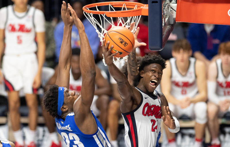 Two Ole Miss men’s basketball players celebrate on the court