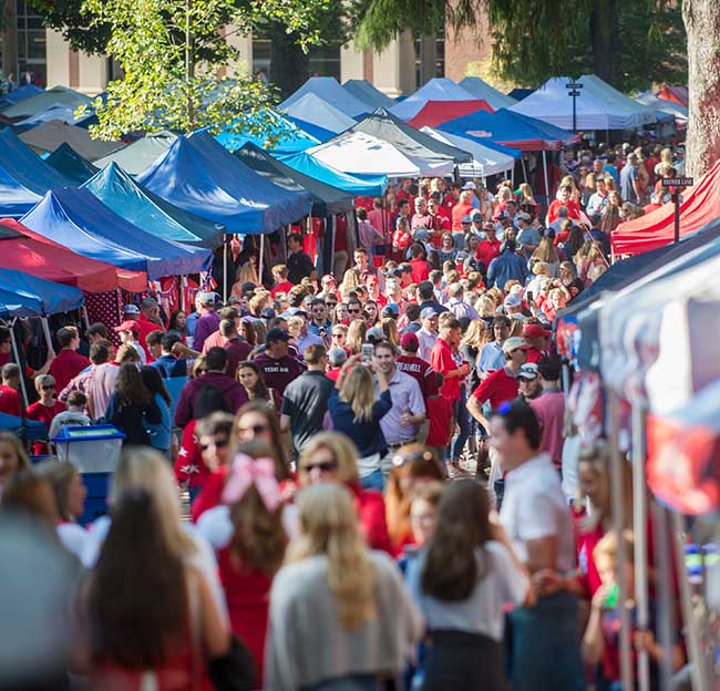 Ole Miss Rebel fans walk and enjoy the atmosphere of the Grove before a home football game.