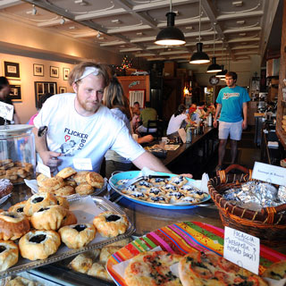 Person in bakery with baked goods in foreground
