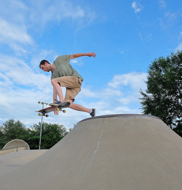 Man catching air while riding skateboard at Oxford skate park 
