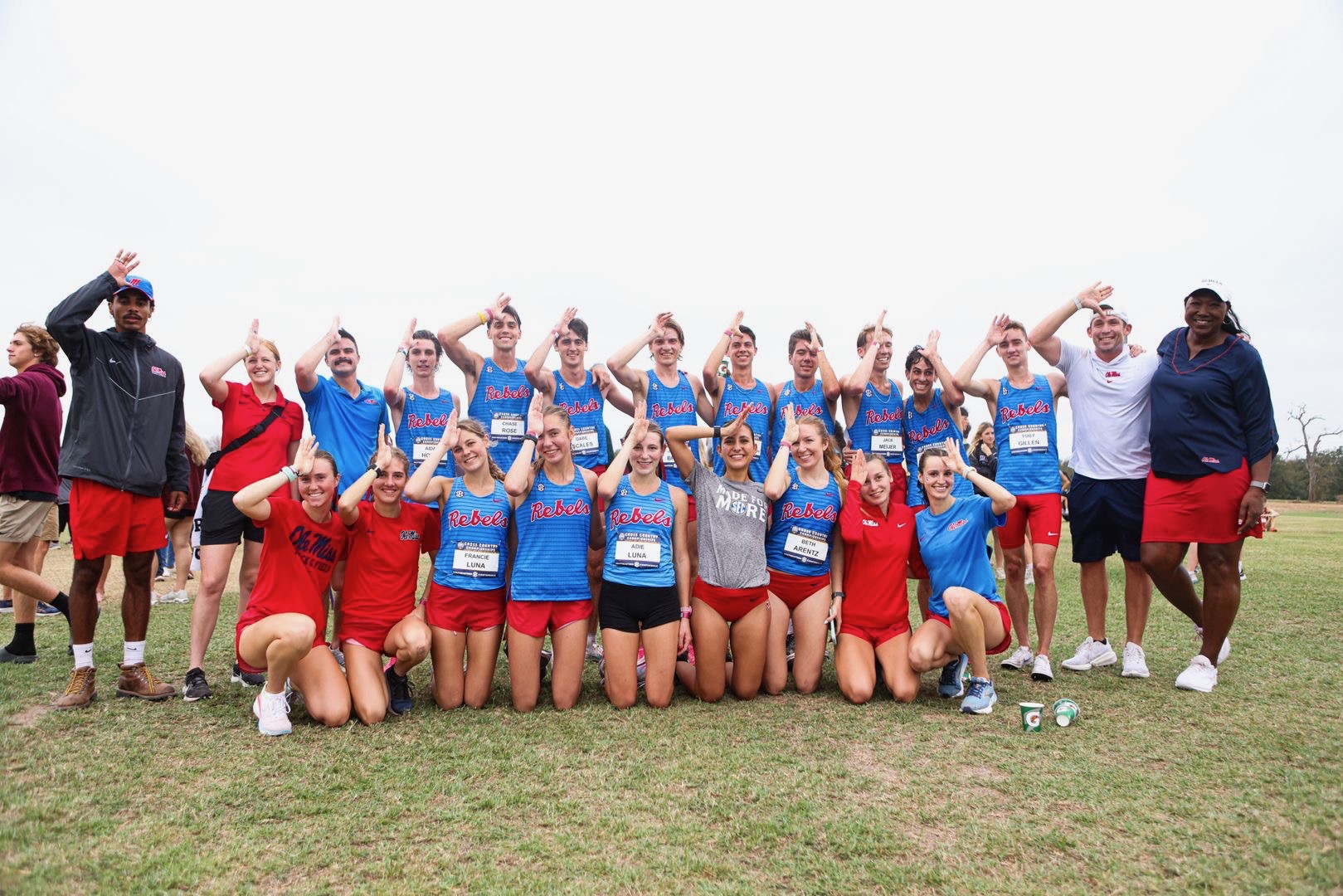 Samantha Oulette posing with the UM cross country team at a meet. 