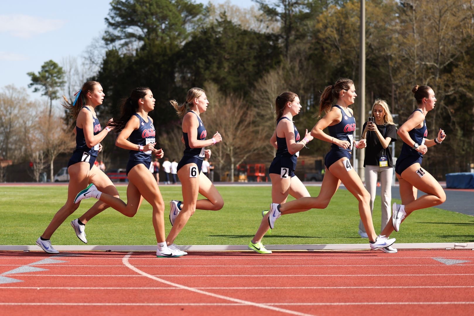 Samantha Oulette running with the cross country team on a track. 