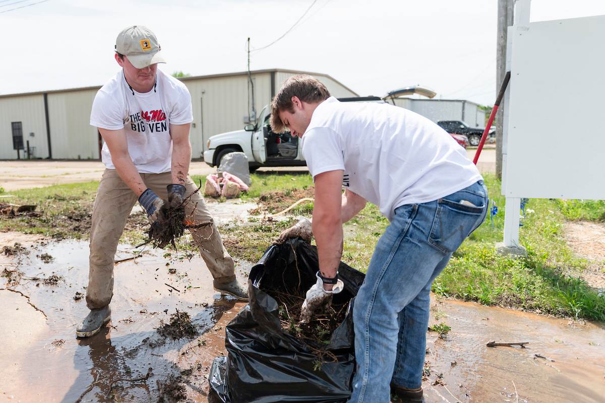 students cleaning waste