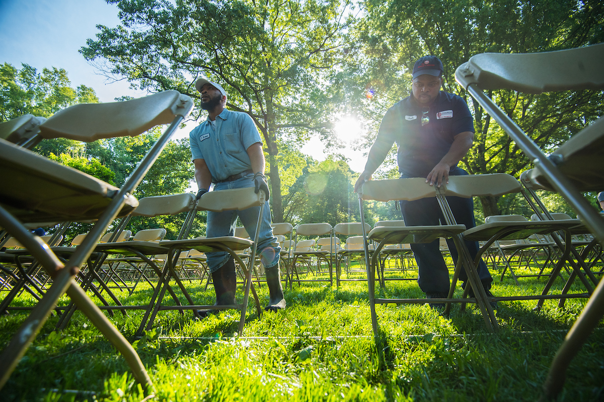Two employees setting up chairs