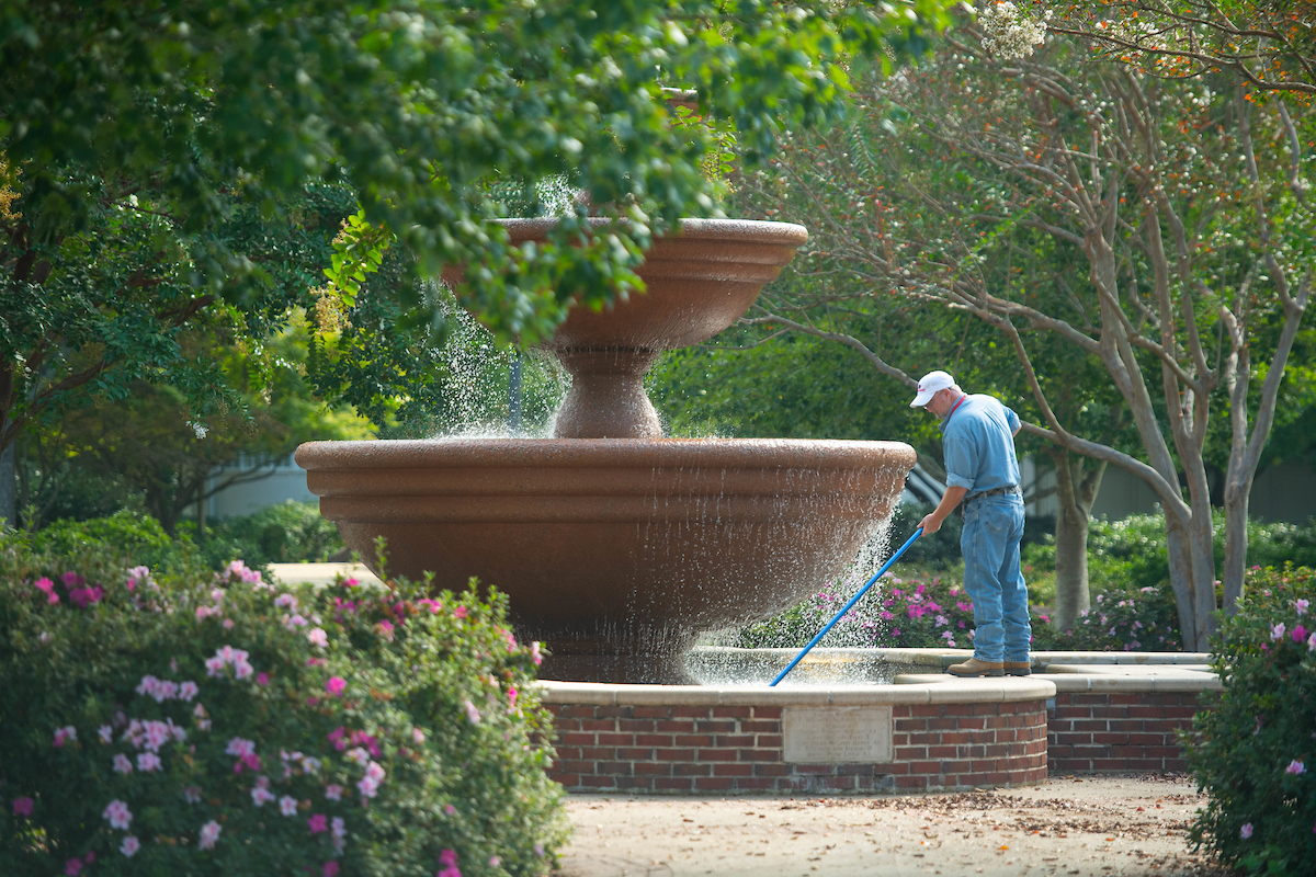 Man cleaning a fountain