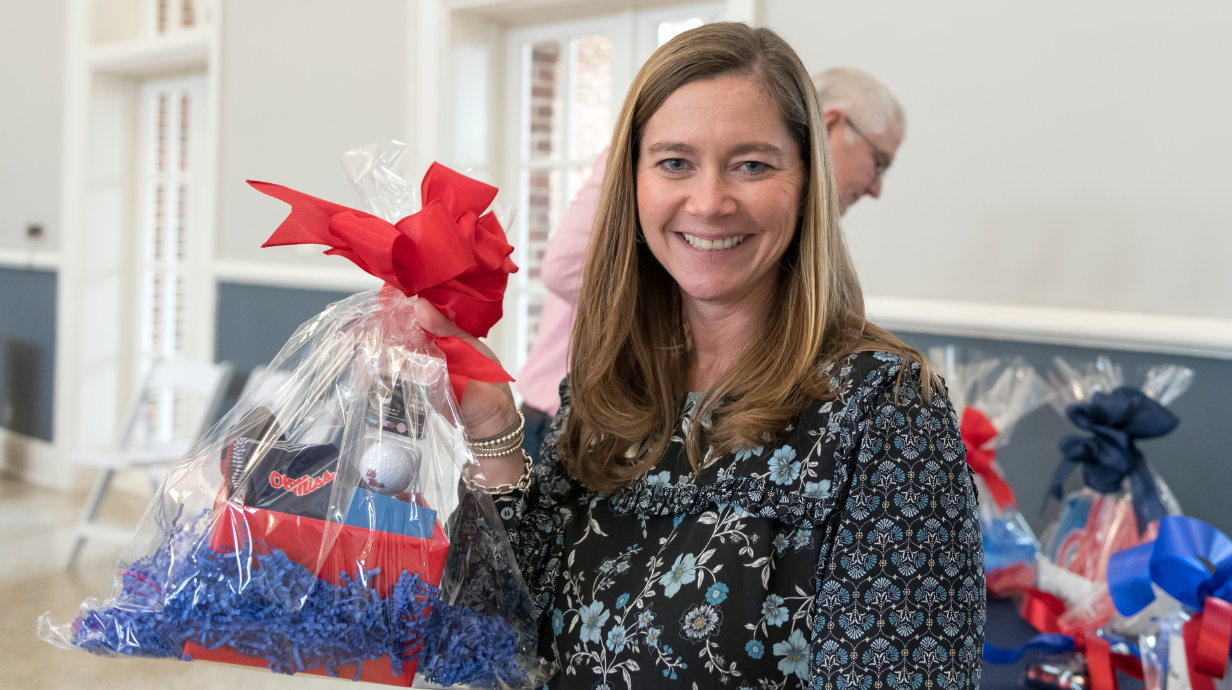 Staff holding gift bag