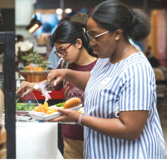 Students and staff select food at Rebel Market