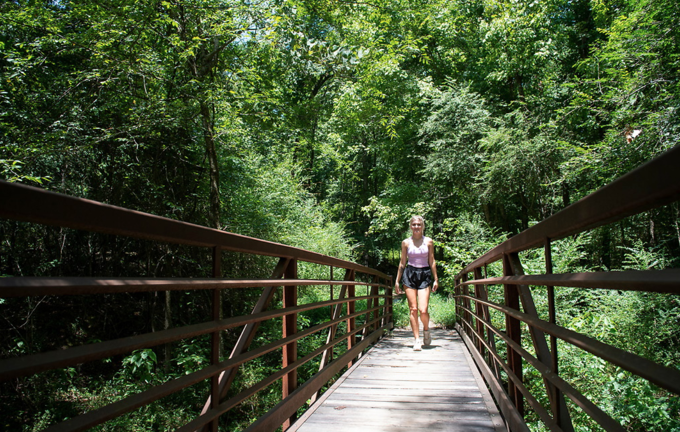 Girl walking through Bailey Woods Trail