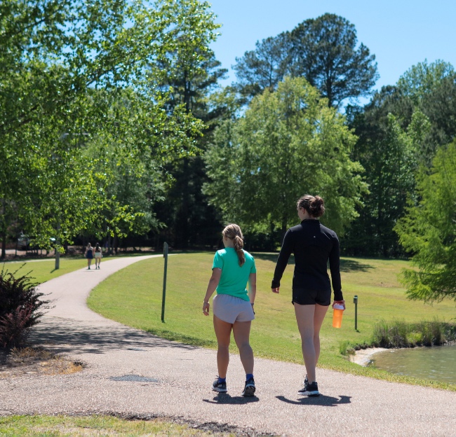 Two young girls walk through Pat Lamar Park