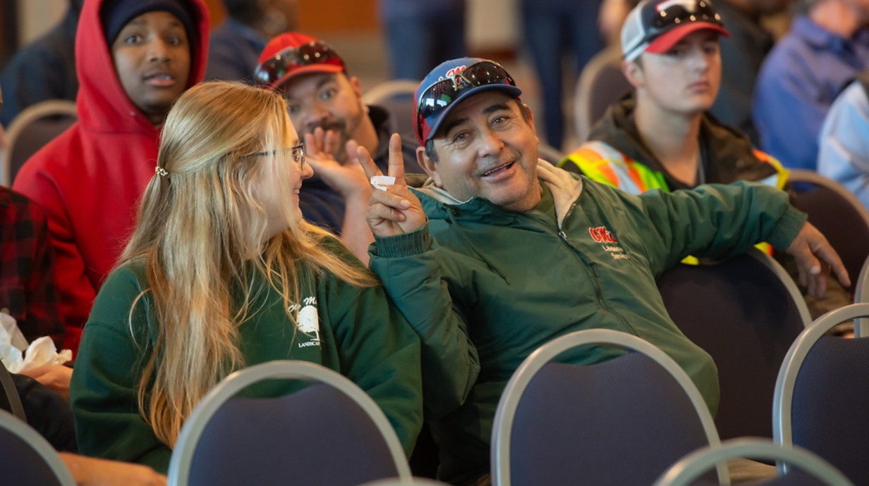 Staff member gives peace sign during gathering