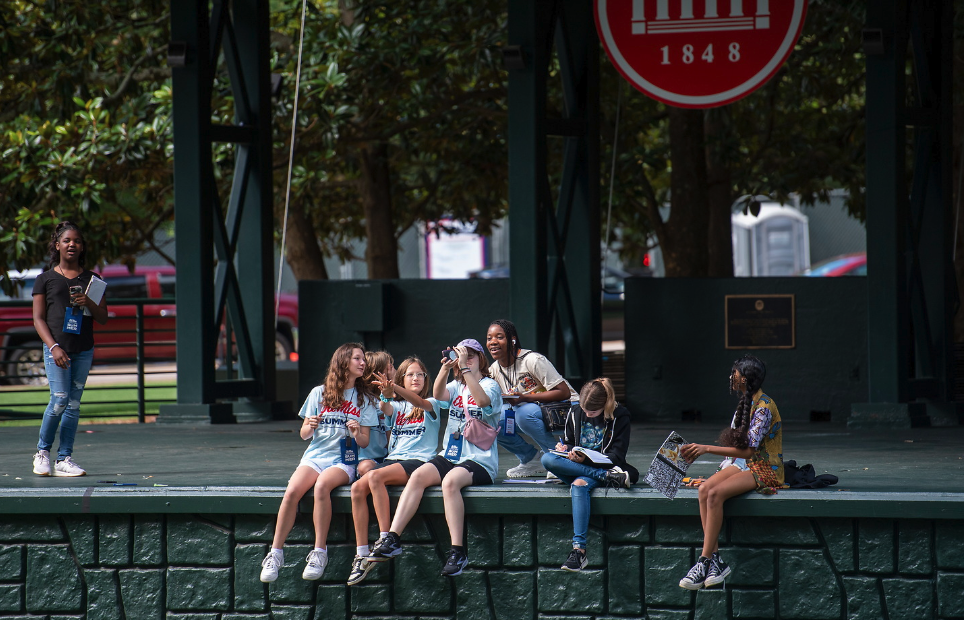 A group of Middle Schoolers gather at the grove during their creative writing summer camp.