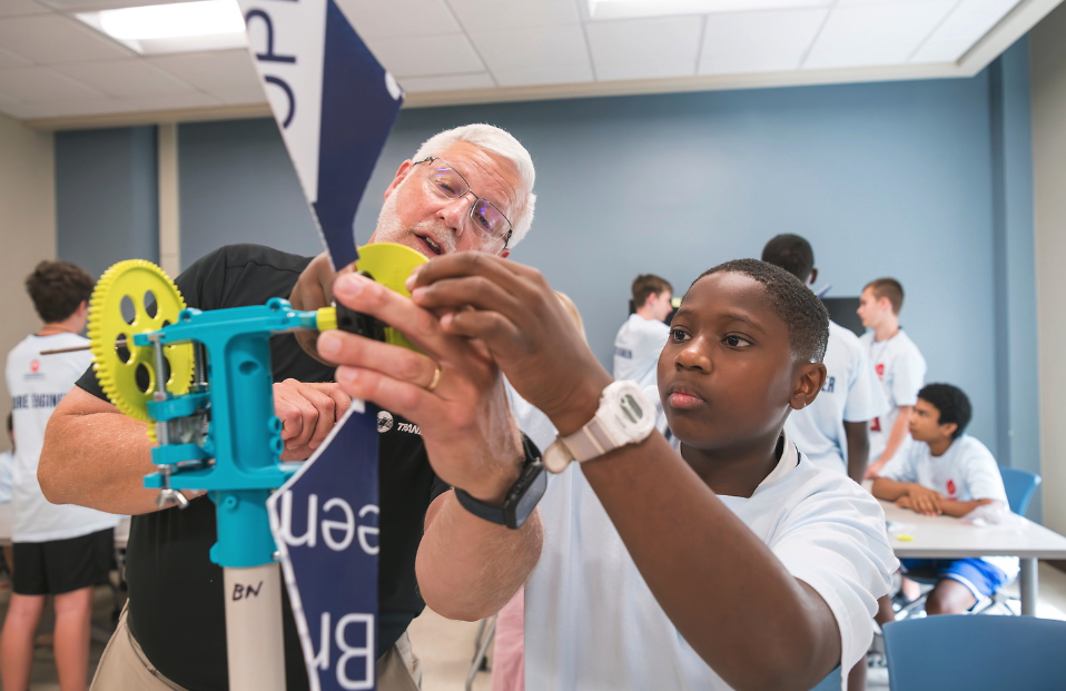 A student and teacher participate in the Middle School Discover Engineering Camp and Trane Technologies