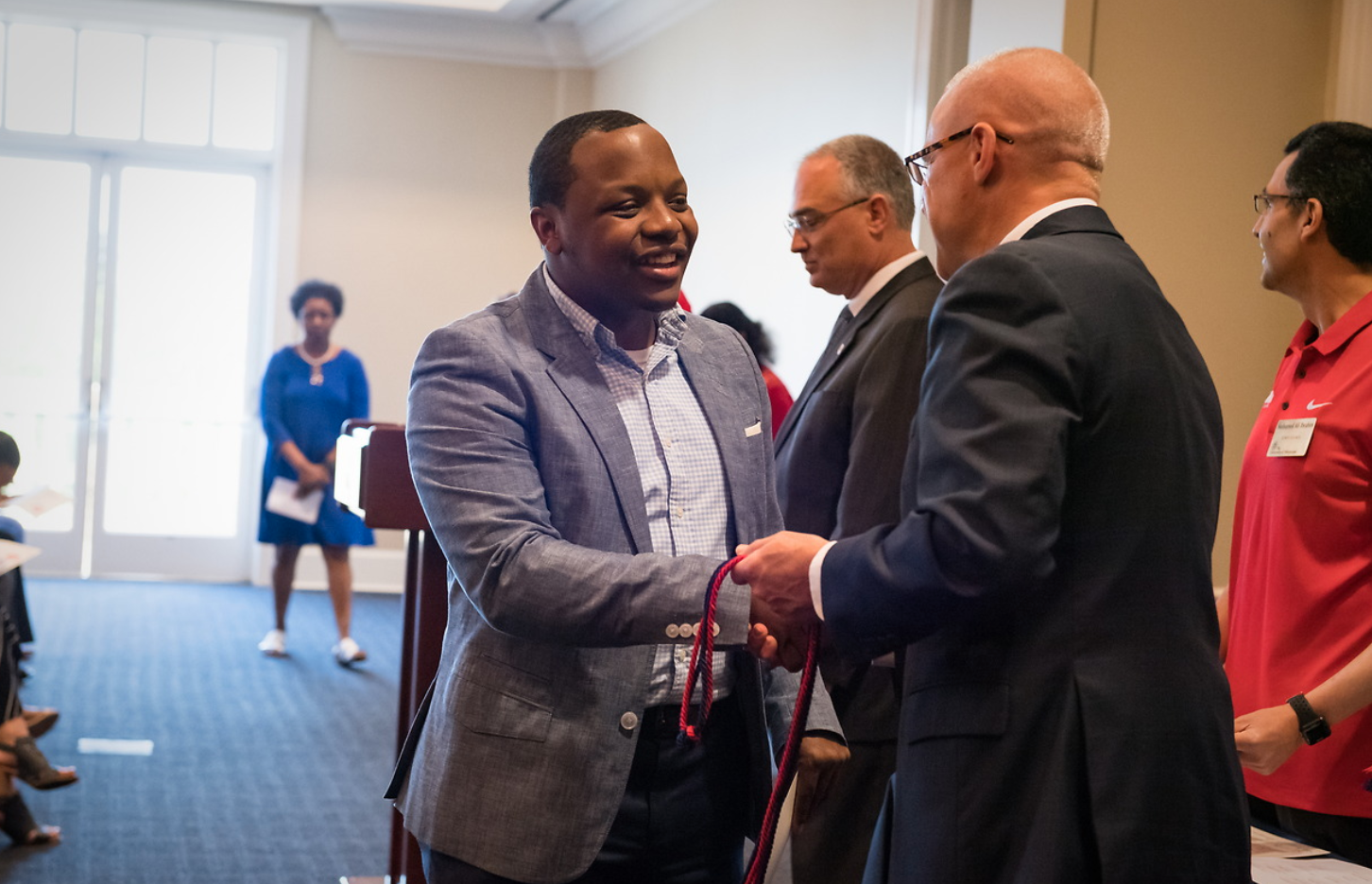 Staff member is recognized at the Red & Blue Ceremony