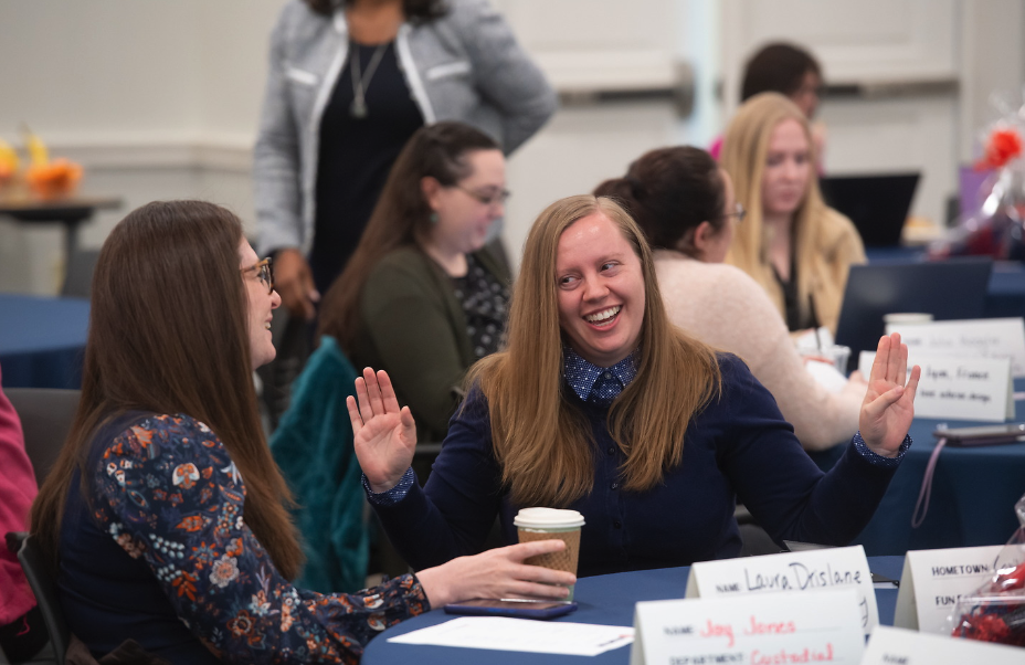 Two employees socialize at a meeting