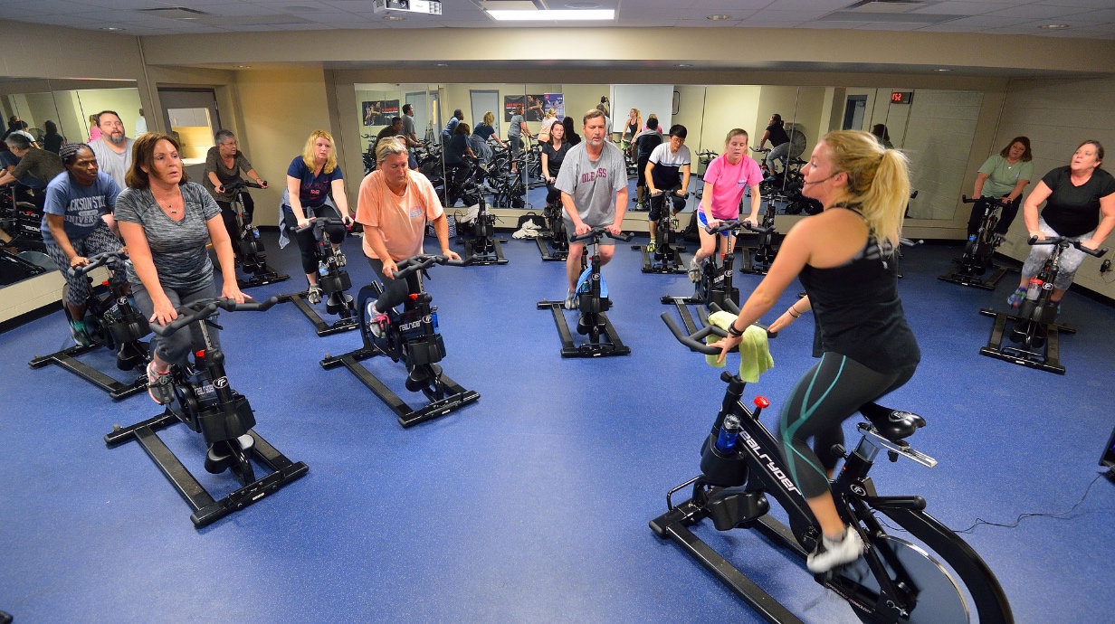 Faculty and staff participate in a group spin class