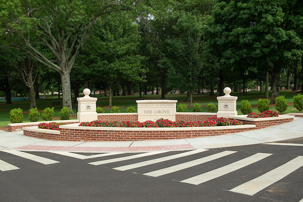 The Grove sign with flowers in front