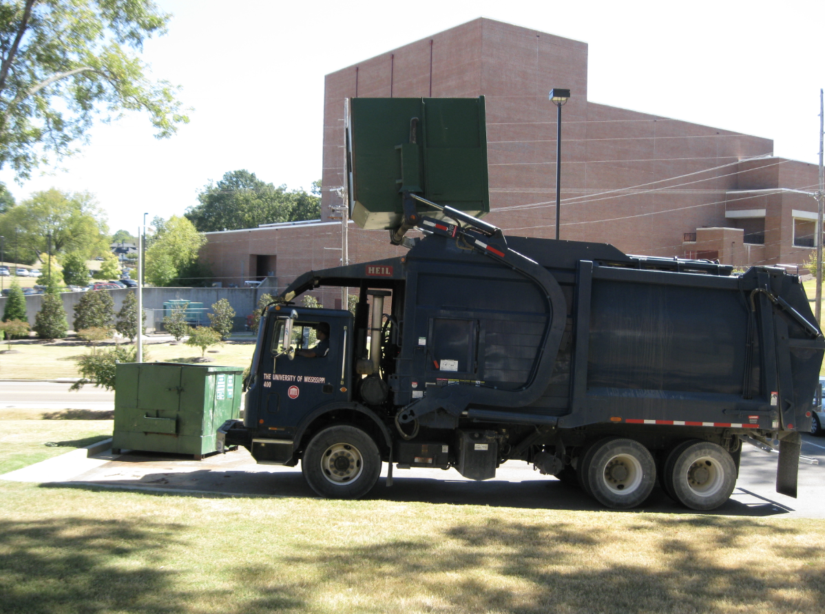 Trash truck emptying a dumpster