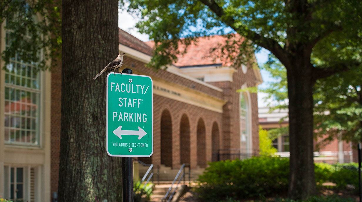 Parking signage that states "faculty/staff parking" on campus.