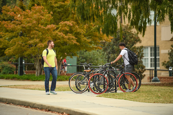 Person parking bike on campus