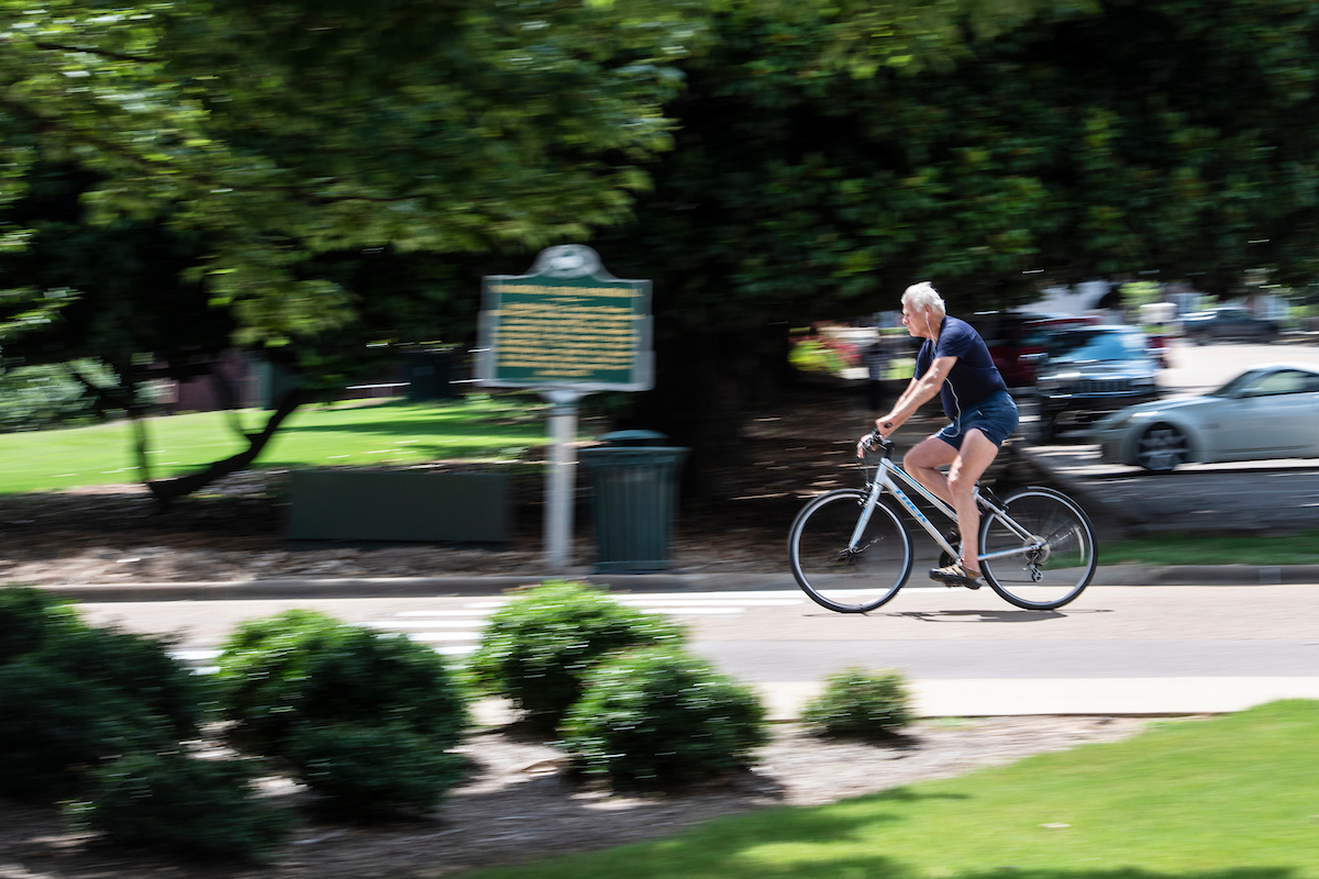 Man cycling on Ole Miss campus