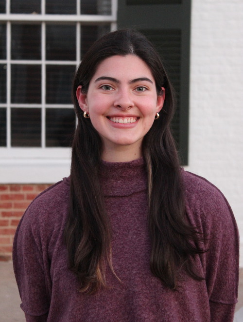 Profile image of Hailey Smith smiling in a purple sweater in front of the UM Lyceum