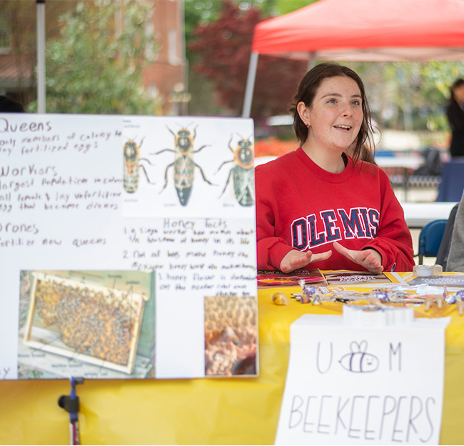 A student volunteer works at a table during Ole Miss Green Week.