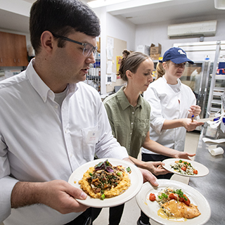 Ole Miss Nutrition and Hospitality Management students prepare and serve meals at the Lenoir Hall dining facility.
