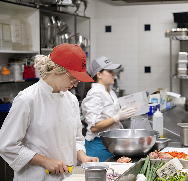 Ole Miss Nutrition and Hospitality Management students prepare and serve meals at the Lenoir Hall dining facility.