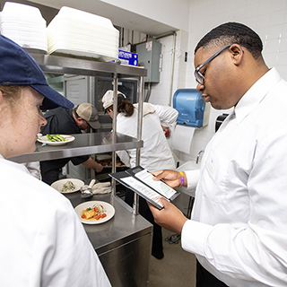 Ole Miss Nutrition and Hospitality Management students prepare and serve meals at the Lenoir Hall dining facility.