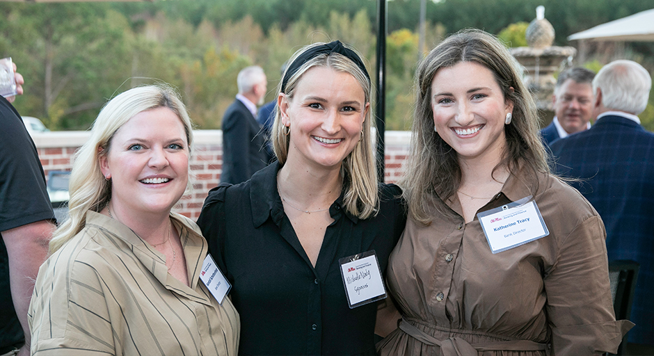 A group of three young women posing for a photo during the reception.