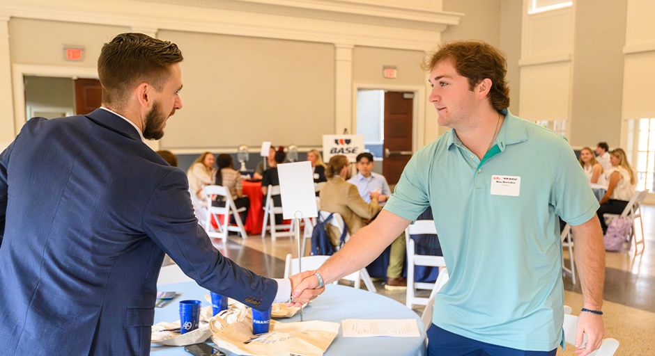 Male student shaking hands with an employer during the BASE Boot Camp.