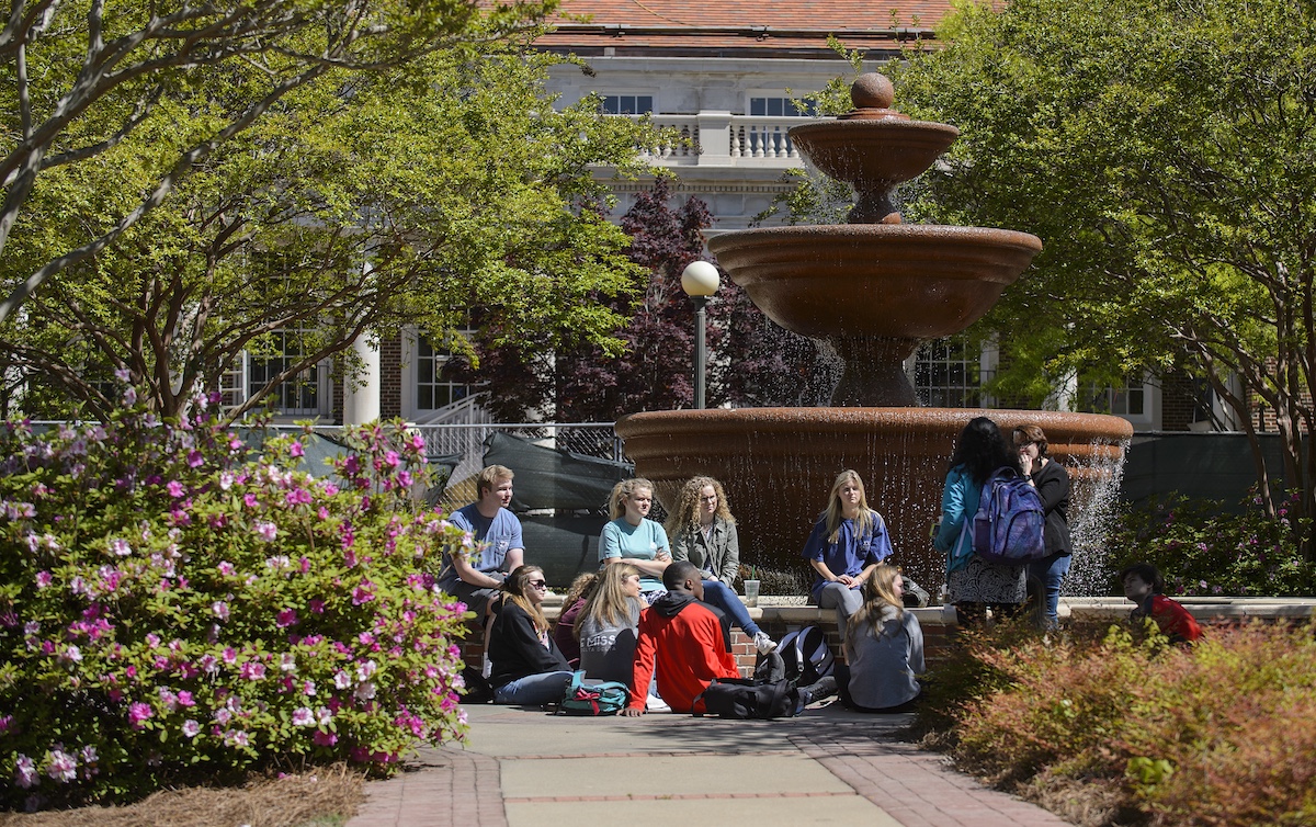 A class is held outdoors beside the Phi Mu Fountain