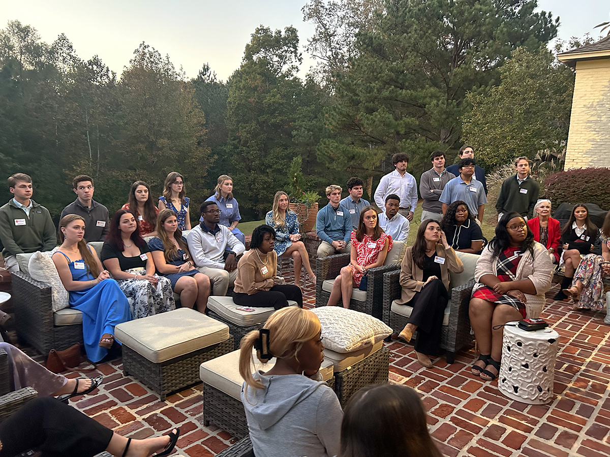 many students sitting and listening to a speaker