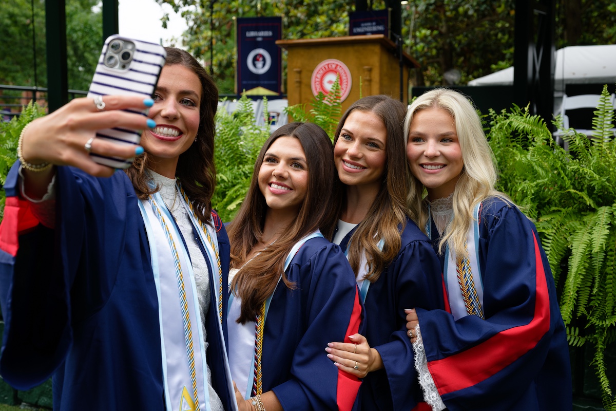 Students pose for a graduation photo